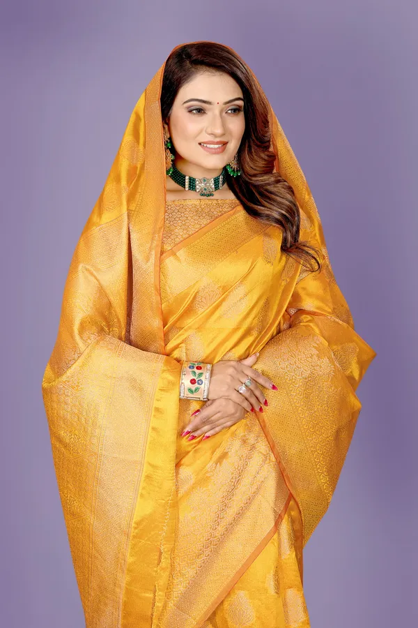 https://d1311wbk6unapo.cloudfront.net/NushopCatalogue/tr:f-webp,w-600,fo-auto/B-1 GOLD_1678552098049_hgkjnfcstu79vt2.jpg__Aaravya Sarees